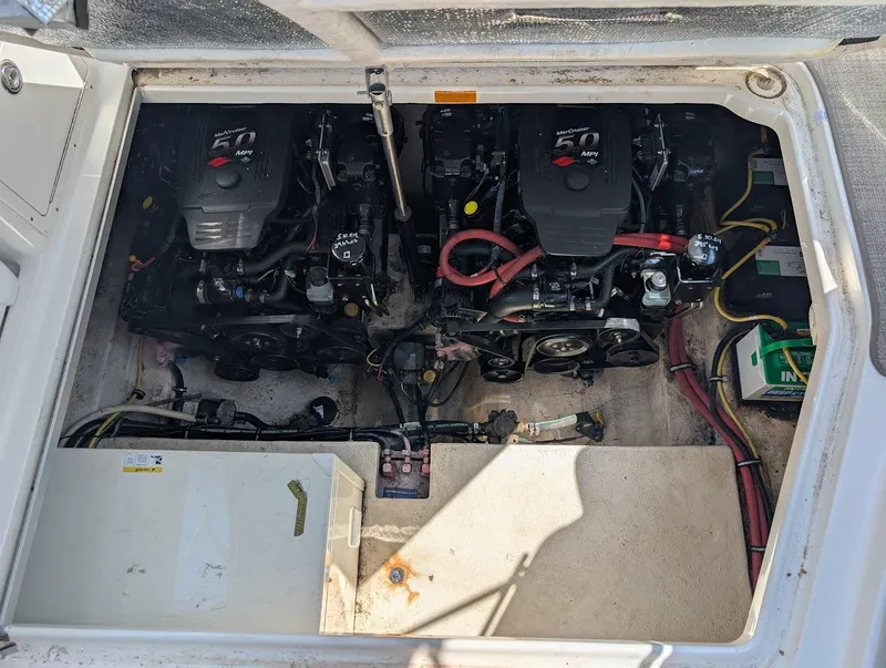 Slide: The Image of Engine compartment of a 2006 Chaparral 310 Signature boat, featuring dual engines. - 35