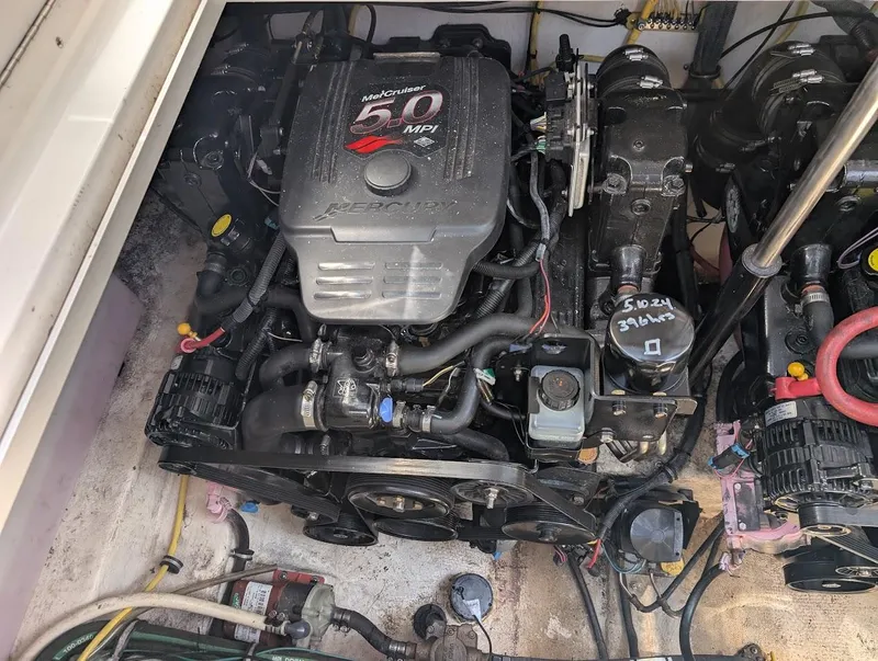 Slide: The Image of Engine compartment of a 2006 Chaparral 310 Signature boat, featuring a MerCruiser 5.0 MPI engine. - 37