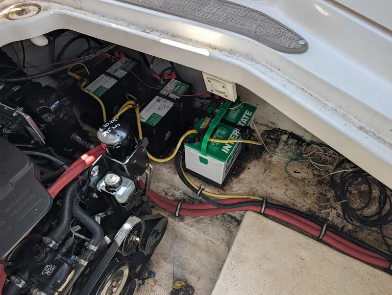 Slide: The Image of Engine compartment of a 2006 Chaparral 310 Signature boat with visible batteries and wiring. - 38
