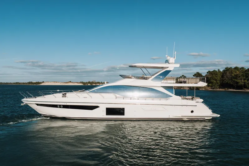 Slide: The Image of 2021 Azimut 72 yacht cruising on a serene blue sea under a clear sky. - 0