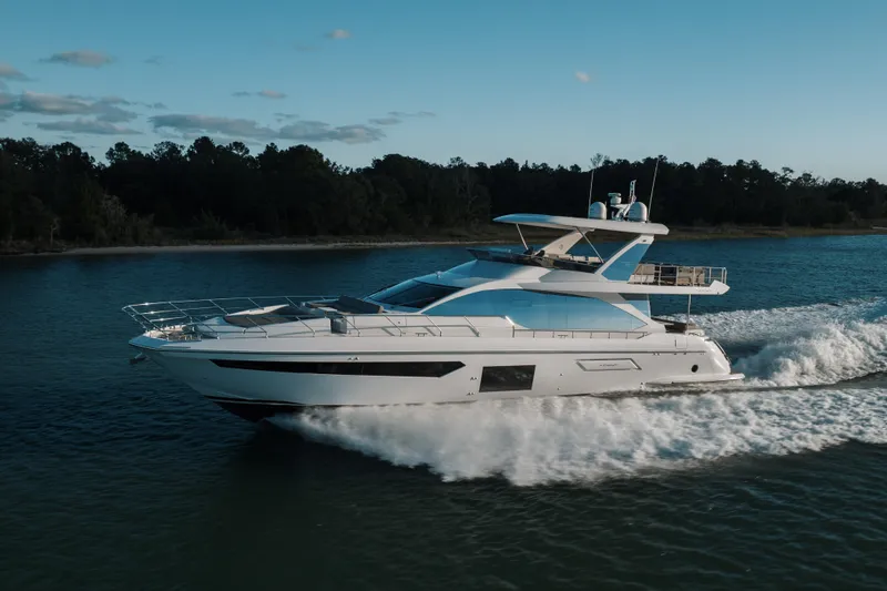 Slide: The Image of Luxury 2021 Azimut 72 yacht cruising on a serene waterway. - 10