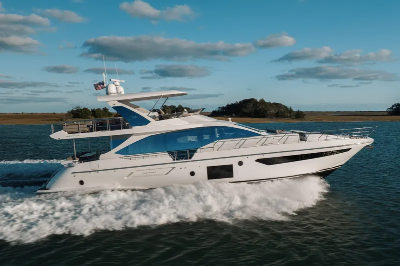 Slide: The Image of 2021 Azimut 72 yacht cruising on open water under a clear blue sky. - 13