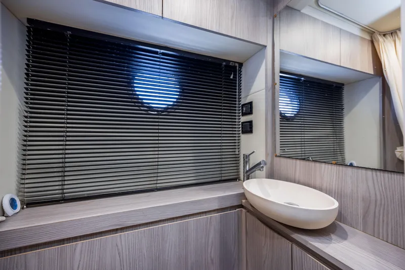 Slide: The Image of Modern bathroom interior on 2021 Azimut 72 yacht, featuring sleek design and round basin sink. - 25