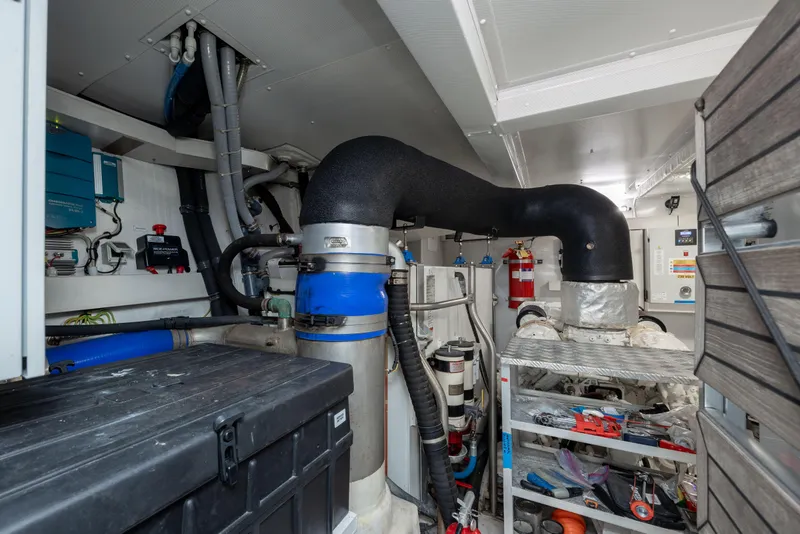 Slide: The Image of Engine room of a 2021 Azimut 72 yacht, featuring pipes and equipment. - 30