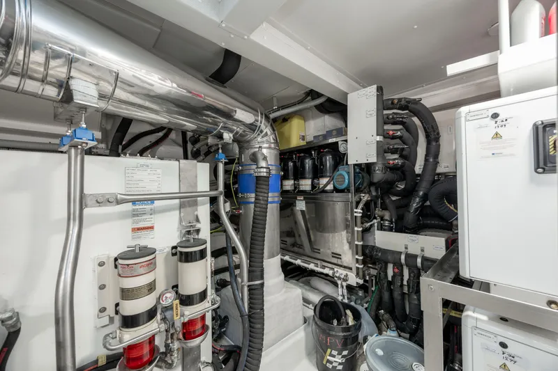 Slide: The Image of Engine room of 2021 Azimut 72 yacht, showcasing complex machinery and piping systems. - 35