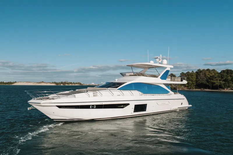 Slide: The Image of Luxury 2021 Azimut 72 yacht cruising on open water under clear blue skies. - 5