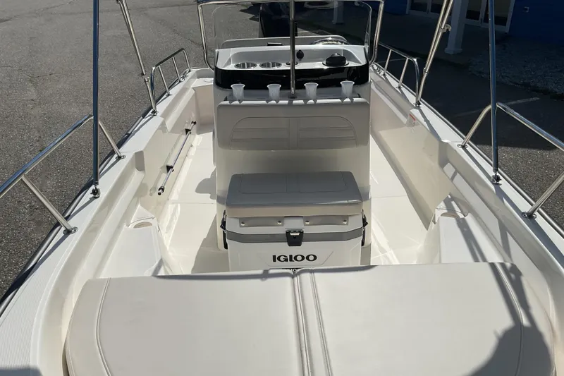 Slide: The Image of 2025 Boston Whaler 150 Montauk boat interior with seating and Igloo cooler. - 8
