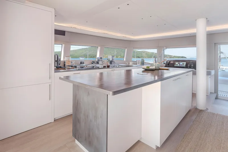 Slide: The Image of Luxurious interior of 2025 Lagoon SIXTY 5 yacht with modern kitchen and panoramic windows. - 13