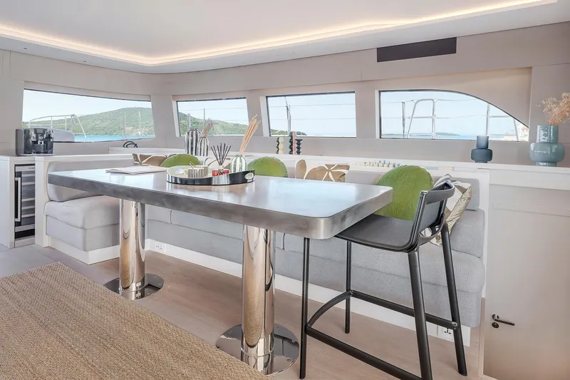 Slide: The Image of Luxurious interior of 2025 Lagoon SIXTY 5 yacht with modern dining area and panoramic windows. - 15