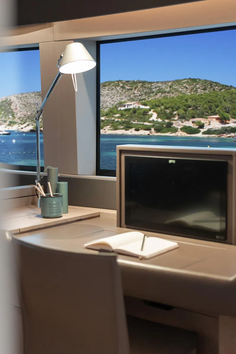 Slide: The Image of Interior view of Lagoon SIXTY 5 yacht, featuring a desk with ocean view, 2025 model. - 39