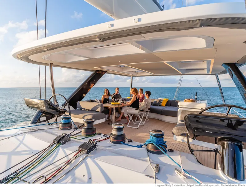 Slide: The Image of Luxurious Lagoon SIXTY 5 yacht deck with people dining, 2025 model, ocean view. - 6