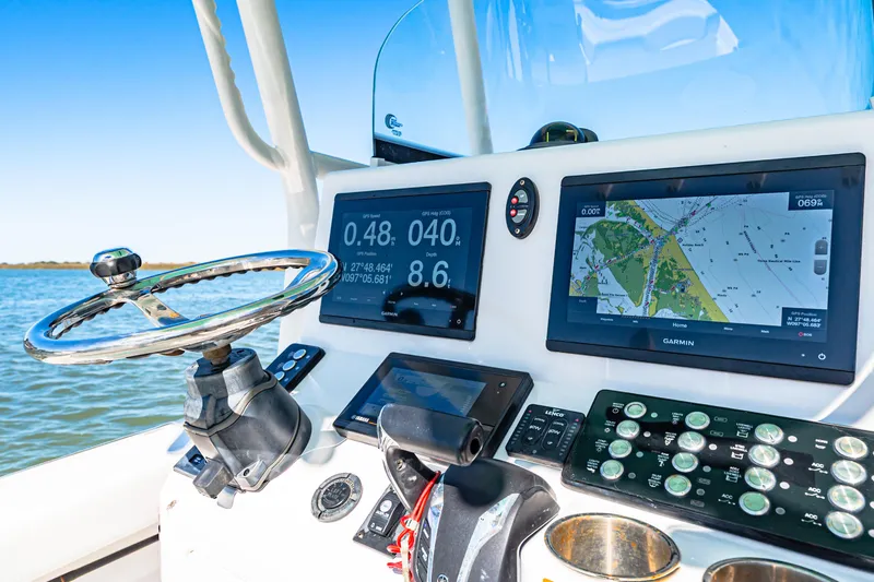 Slide: The Image of Dashboard of 2022 Caymas 26 HB boat with navigation screens and controls. - 10