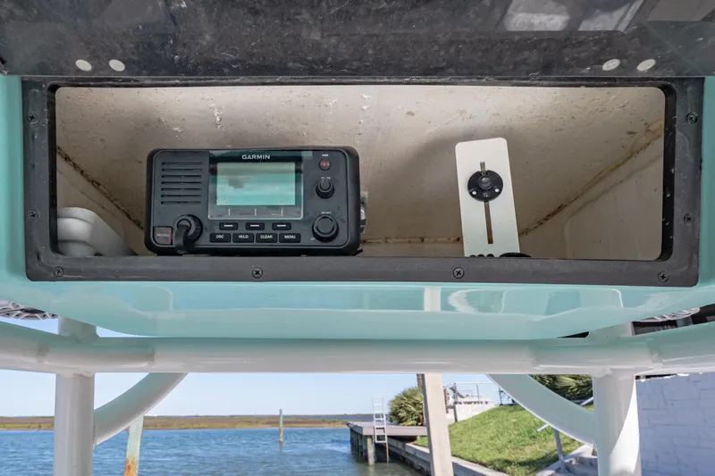 Slide: The Image of 2022 Caymas 26 HB boat with Garmin marine radio in storage compartment. - 13