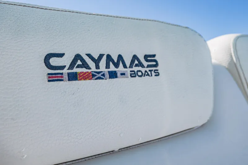 Slide: The Image of Caymas Boats logo on 2022 Caymas 26 HB seat, featuring nautical flags. - 14