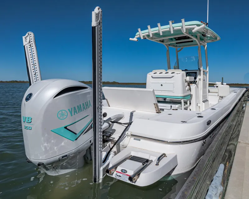 Slide: The Image of 2022 Caymas 26 HB boat with Yamaha V6 engine docked on a sunny day. - 21