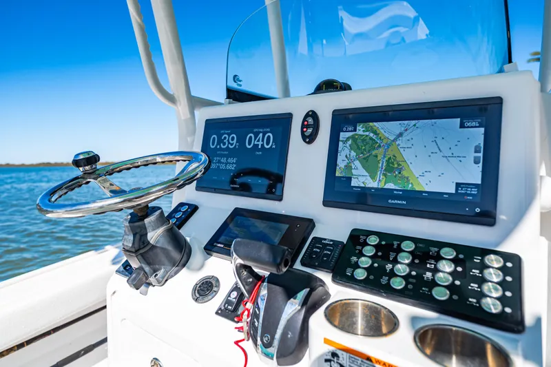 Slide: The Image of Control panel of 2022 Caymas 26 HB boat with navigation screens and steering wheel. - 9