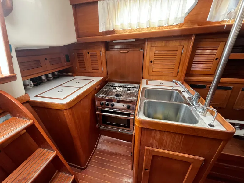 Slide: The Image of 1986 Bristol 38.8 yacht kitchen with wood cabinetry, dual sinks, and stove. - 11