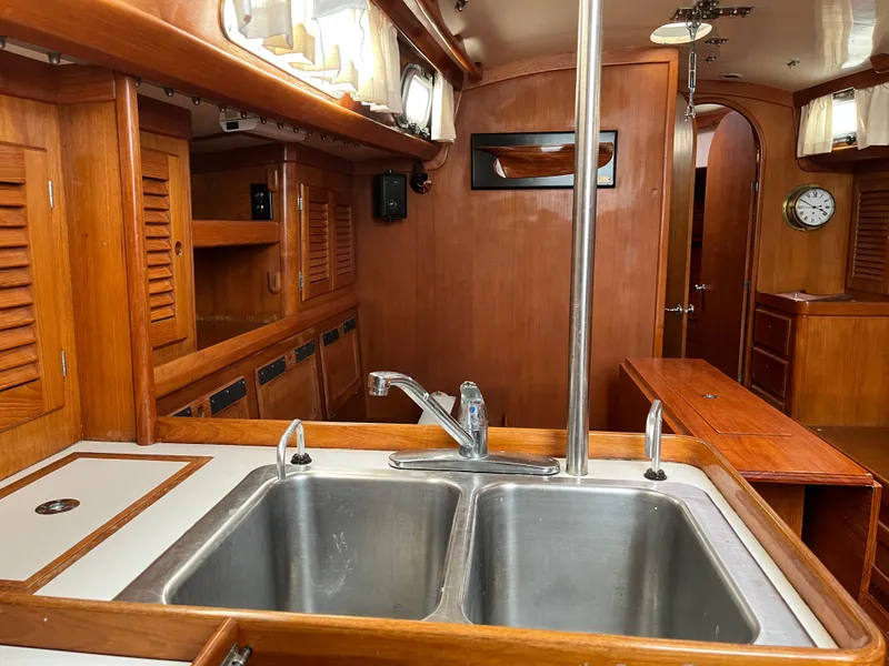 Slide: The Image of Interior of 1986 Bristol 38.8 sailboat with wooden cabinetry and dual kitchen sink. - 12