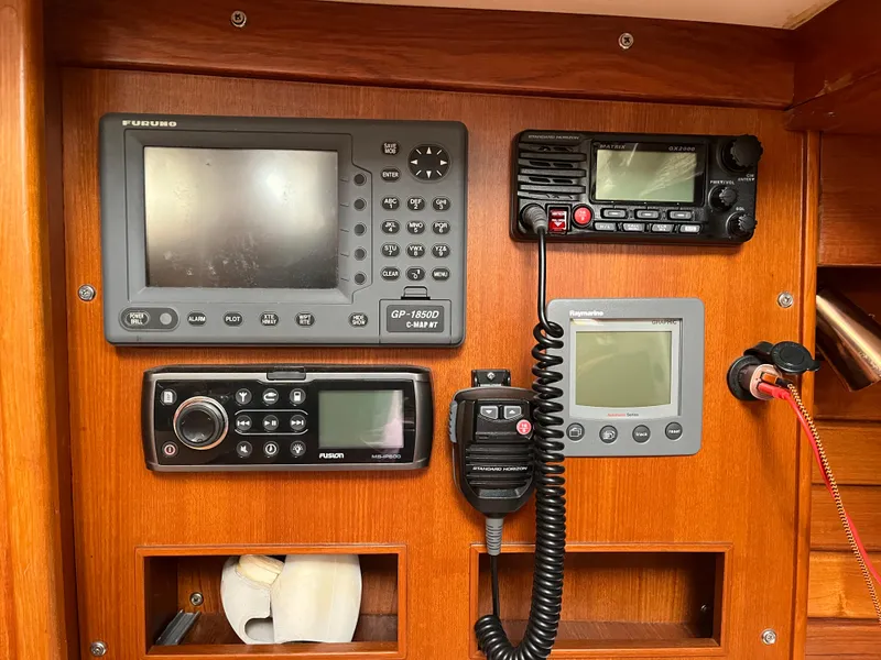 Slide: The Image of Navigation equipment on a 1986 Bristol 38.8 sailboat, featuring GPS and communication devices. - 13
