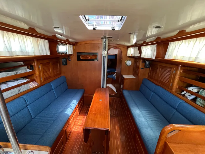 Slide: The Image of Interior of 1986 Bristol 38.8 sailboat with blue seating and wooden finishes. - 17