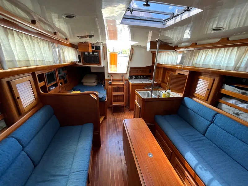Slide: The Image of Interior of 1986 Bristol 38.8 sailboat with blue seating and wooden finishes. - 18