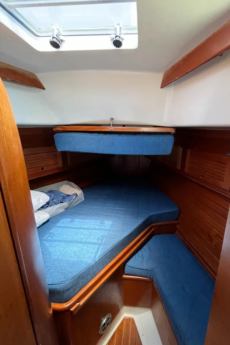 Slide: The Image of 1986 Bristol 38.8 yacht cabin with blue bedding and wooden interior. - 23