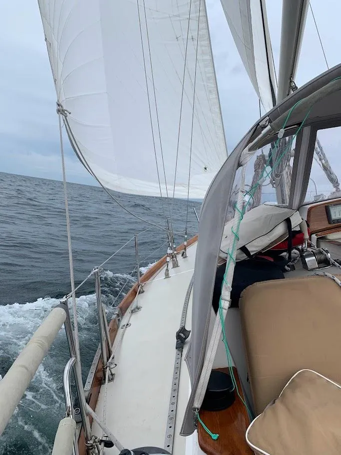 Slide: The Image of Sailing on a 1986 Bristol 38.8 yacht with white sails on open water. - 4