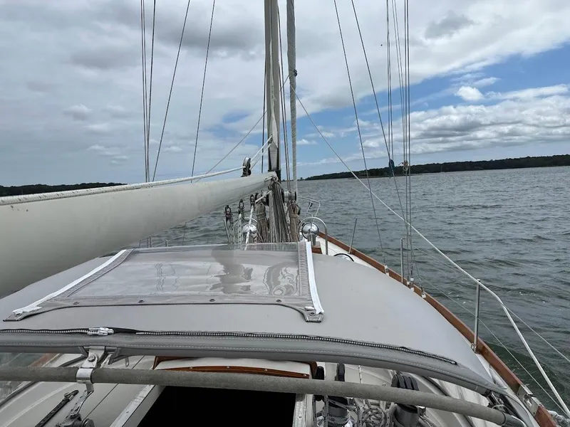 Slide: The Image of 1986 Bristol 38.8 sailboat on calm waters under cloudy sky. - 6