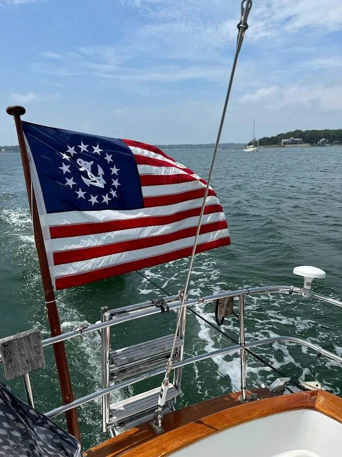 Slide: The Image of Sailing on a 1986 Bristol 38.8 yacht with a nautical flag, ocean view. - 7
