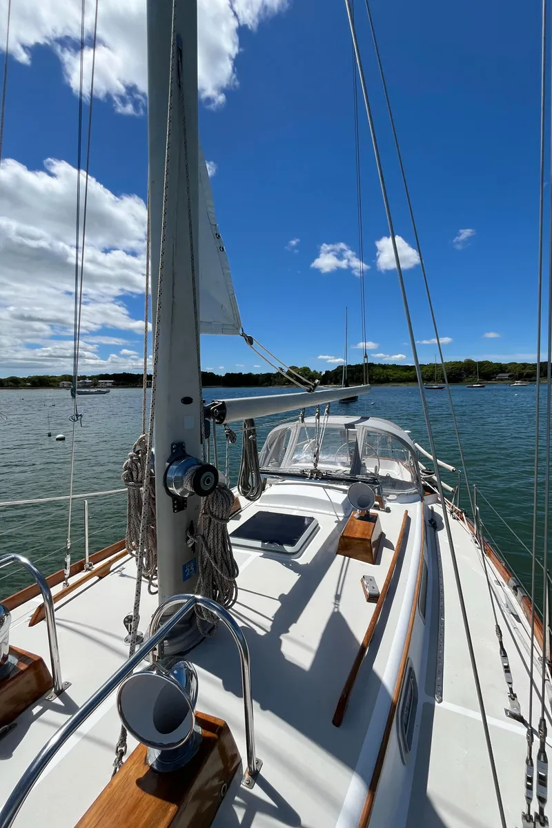Slide: The Image of 1986 Bristol 38.8 sailboat on calm water under a clear blue sky. - 9