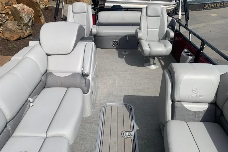 Slide: The Image of 2024 Regency R250DL3 pontoon boat with luxurious gray seating and spacious deck layout. - 4