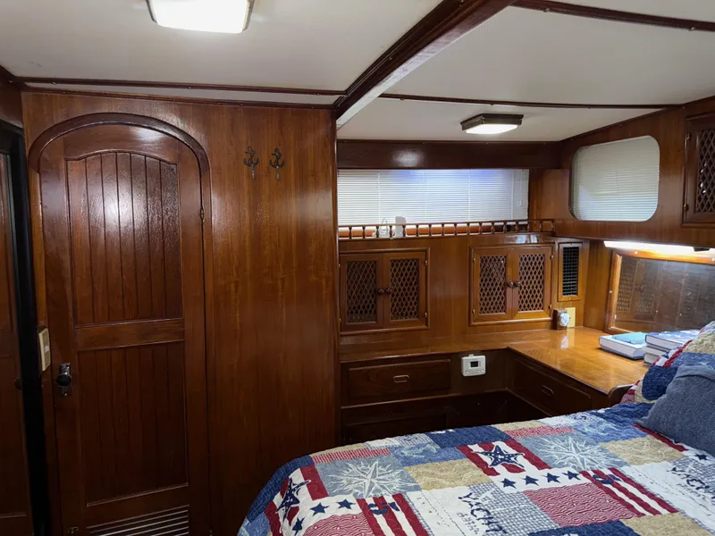 Slide: The Image of 1984 Marine Trader Sun Deck cabin with wooden interior and cozy bed. - 19