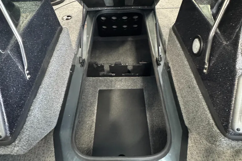 Slide: The Image of 2023 Ranger VS1782 Angler boat storage compartment with carpeted interior and metal supports. - 25