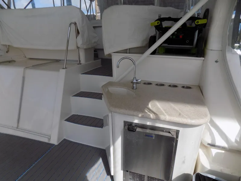 Slide: The Image of 2005 Silverton 43 Motor Yacht interior with kitchenette and stairs. - 13