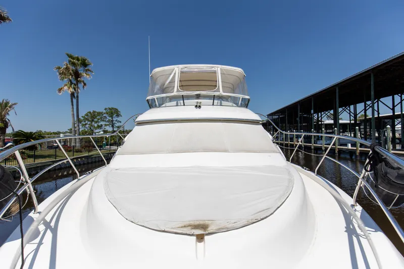 Slide: The Image of 2005 Silverton 43 Motor Yacht docked under clear blue sky. - 16