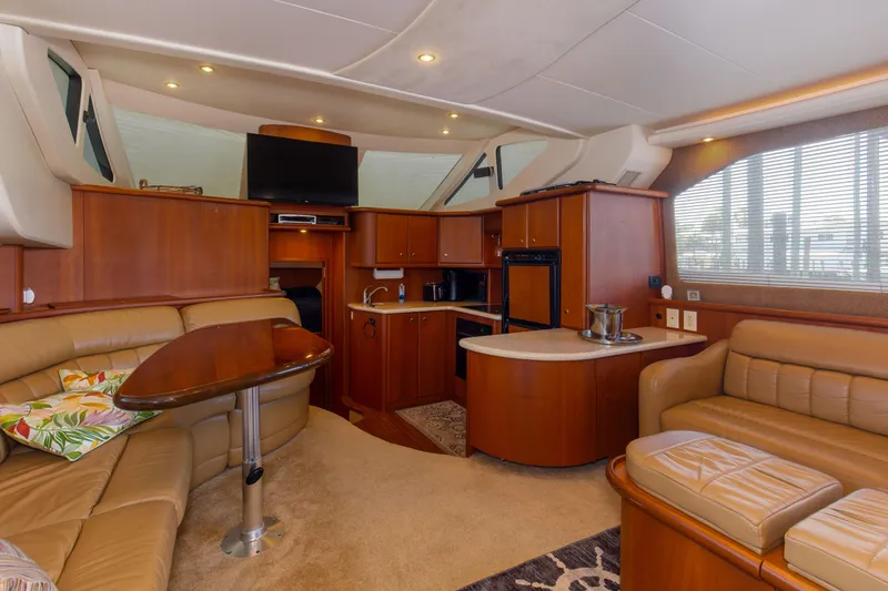 Slide: The Image of Luxurious interior of 2005 Silverton 43 Motor Yacht with elegant wood finishes and plush seating. - 19