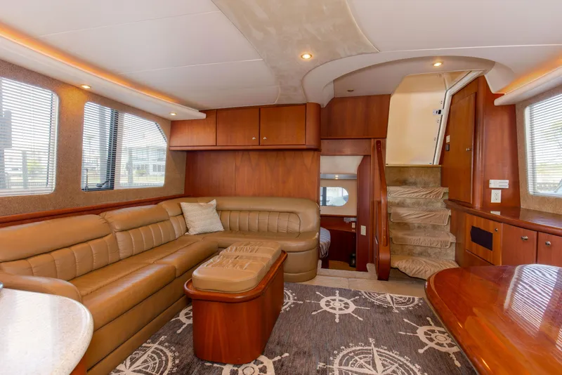 Slide: The Image of Luxurious interior of a 2005 Silverton 43 Motor Yacht with leather seating and nautical decor. - 20