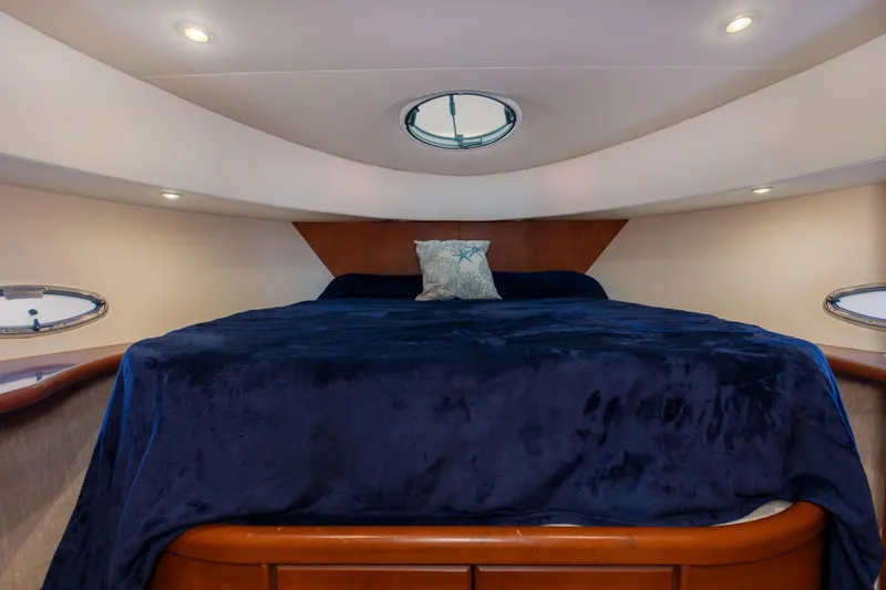 Slide: The Image of Luxurious bedroom in 2005 Silverton 43 Motor Yacht with plush bedding and elegant lighting. - 32