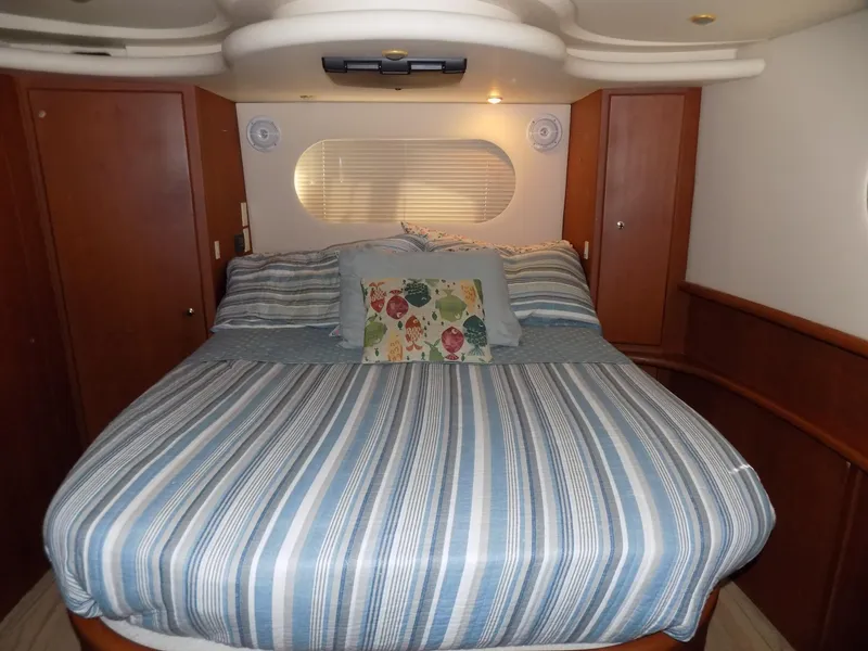 Slide: The Image of Luxurious bedroom in 2005 Silverton 43 Motor Yacht with striped bedding and floral pillow. - 33
