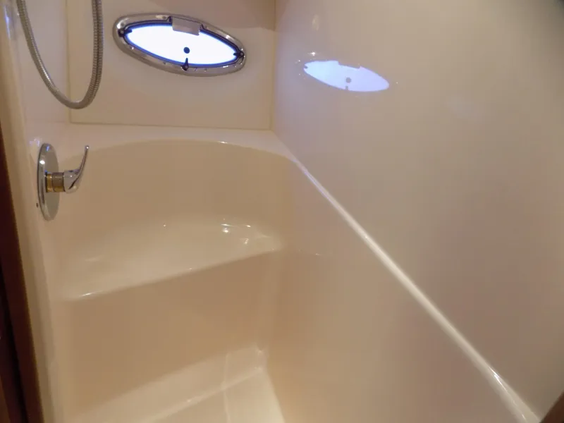 Slide: The Image of Bathroom interior of 2005 Silverton 43 Motor Yacht with shower and porthole window. - 38