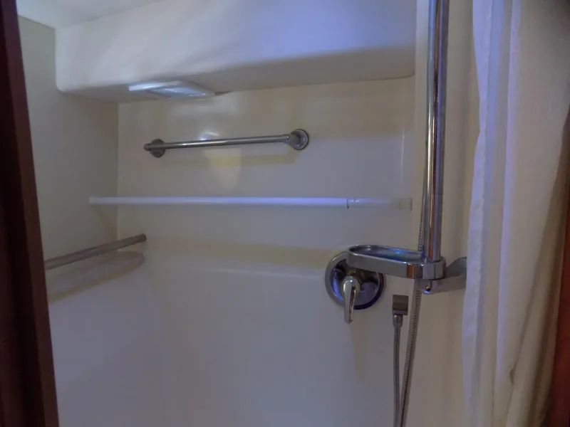 Slide: The Image of Shower area in 2005 Silverton 43 Motor Yacht with chrome fixtures and towel bars. - 39