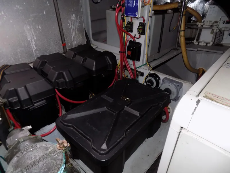 Slide: The Image of Engine room of 2005 Silverton 43 Motor Yacht with battery boxes and wiring. - 43
