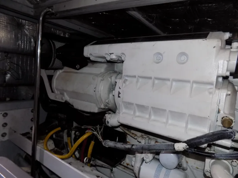 Slide: The Image of Engine compartment of a 2005 Silverton 43 Motor Yacht, showcasing mechanical components and wiring. - 47