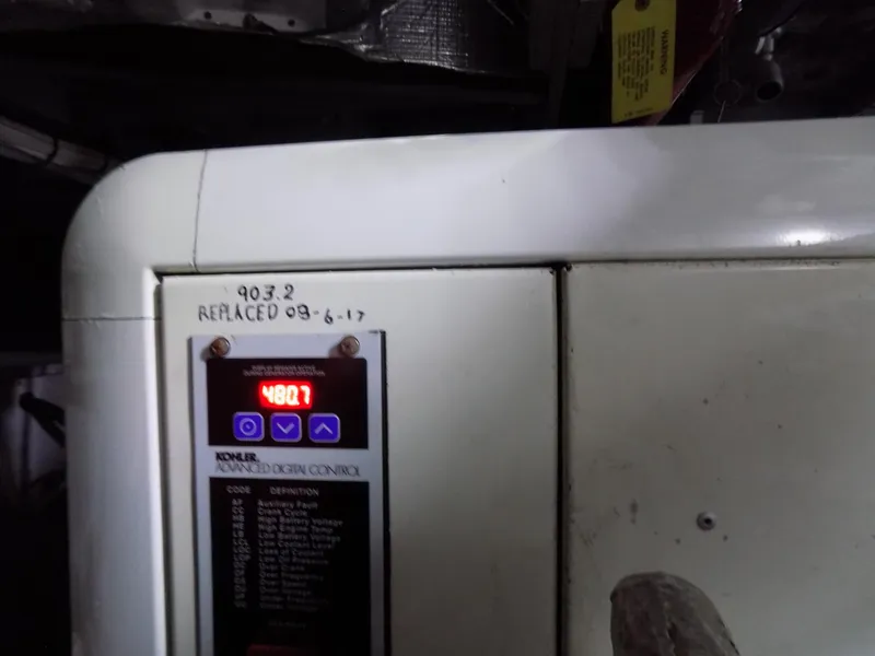 Slide: The Image of Control panel of a 2005 Silverton 43 Motor Yacht with digital display and handwritten notes. - 48