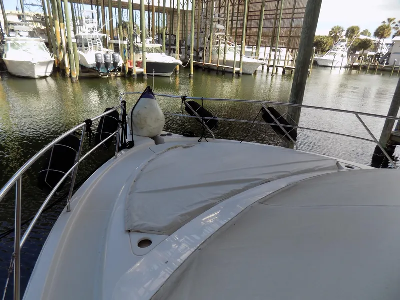 Slide: The Image of 2005 Silverton 43 Motor Yacht docked in a marina, surrounded by other boats. - 53