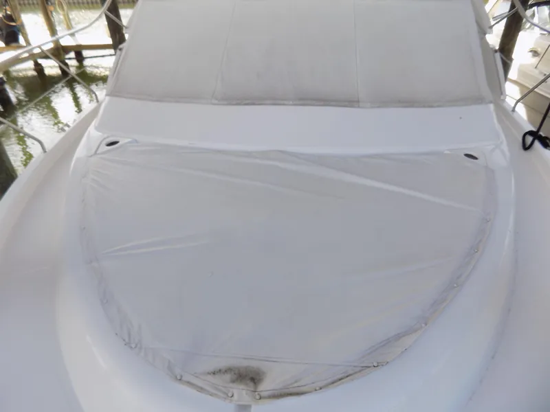 Slide: The Image of 2005 Silverton 43 Motor Yacht with covered bow area, docked in a marina. - 56
