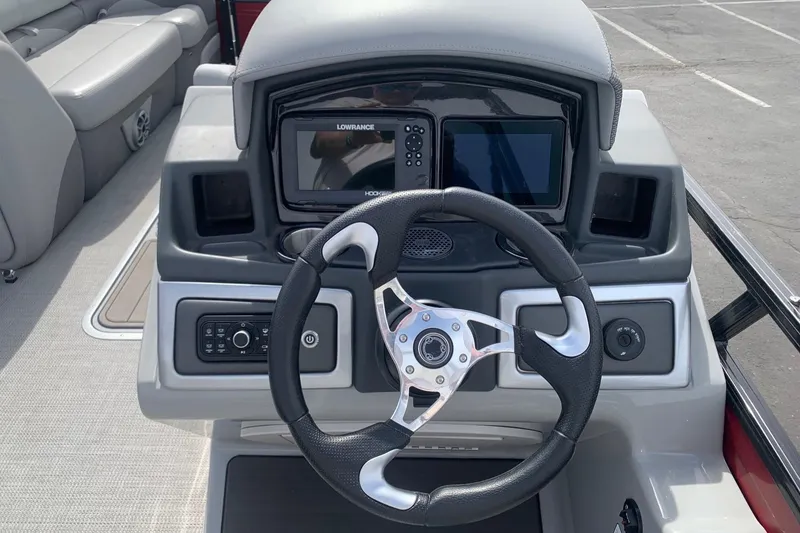 Slide: The Image of 2024 Regency R250DL3 boat dashboard with steering wheel and navigation system. - 1