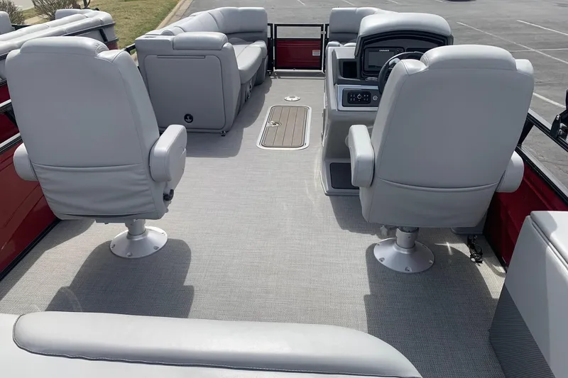 Slide: The Image of 2024 Regency R250DL3 pontoon boat interior with plush seating and modern helm. - 2