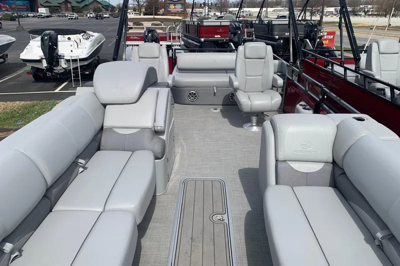 Slide: The Image of 2024 Regency R250DL3 pontoon boat with luxurious gray seating and spacious deck layout. - 4