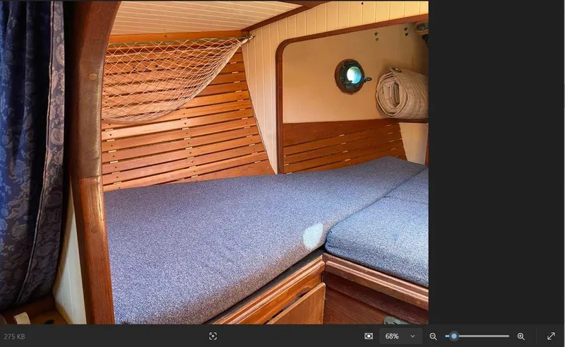 Slide: The Image of Cozy cabin interior of 1990 Bristol Channel Cutter 28 sailboat with wooden accents. - 16